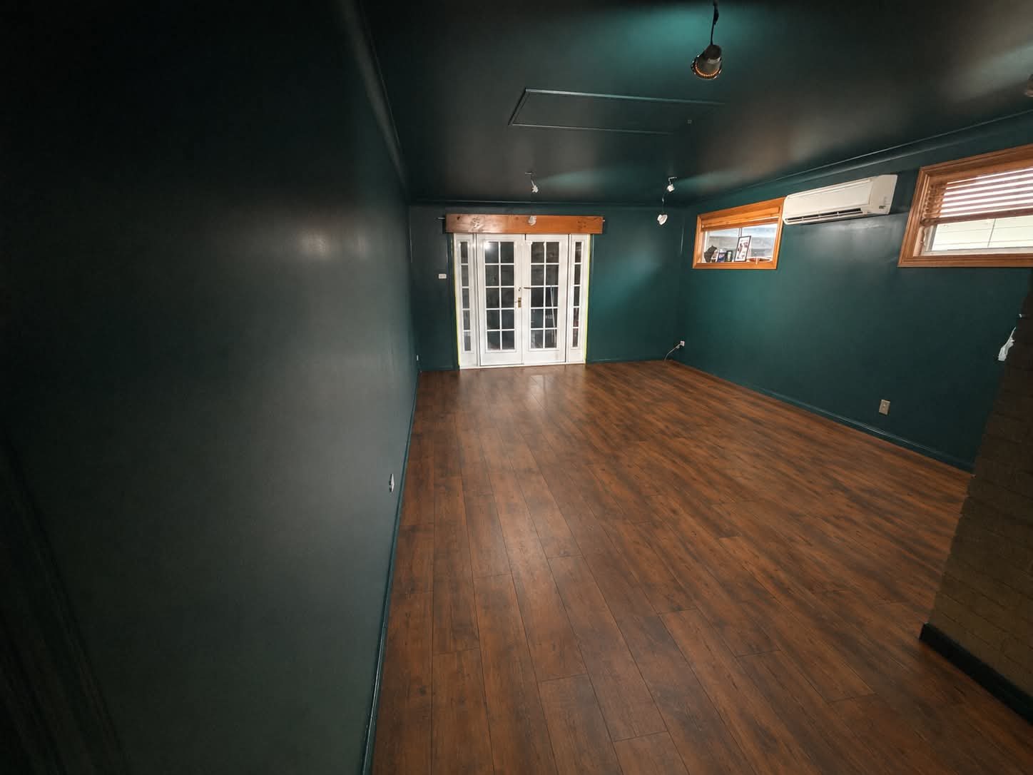 Deep green feature room repainted by Hughesys Painting Newcastle, photo posted with a 5-star Google review