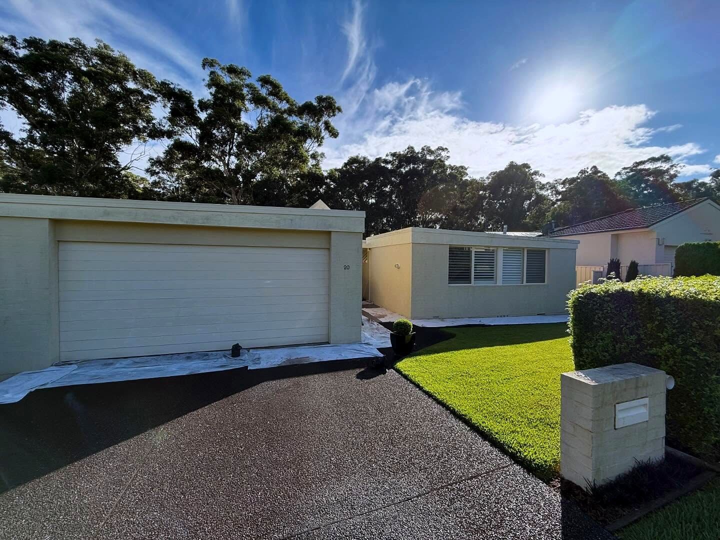 Freshly painted Newcastle home exterior with landscaped garden by Hughesys Painting