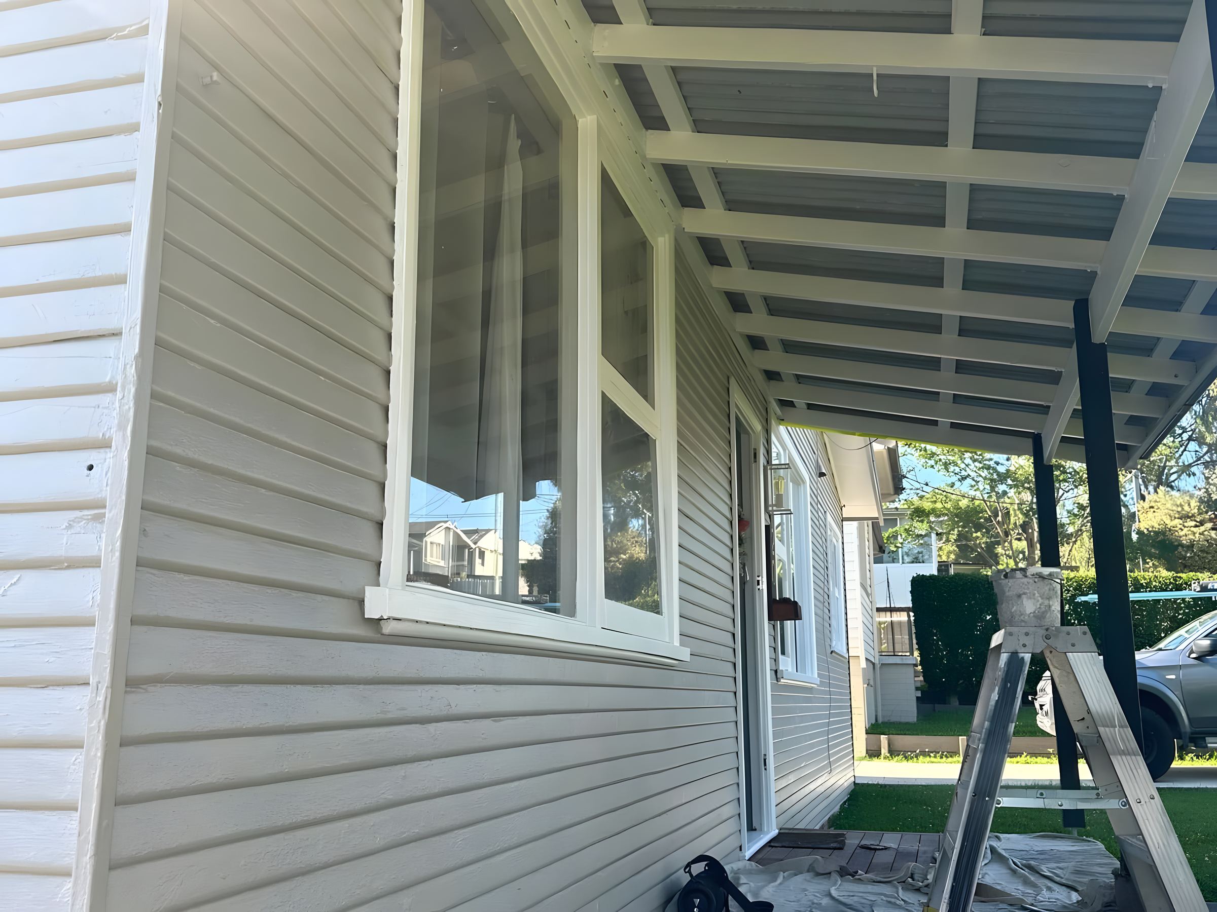 Weatherboard verandah partway through repainting