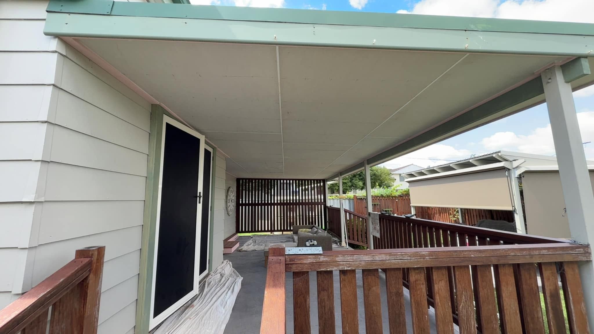 Covered verandah and weatherboard wall on a repainted home