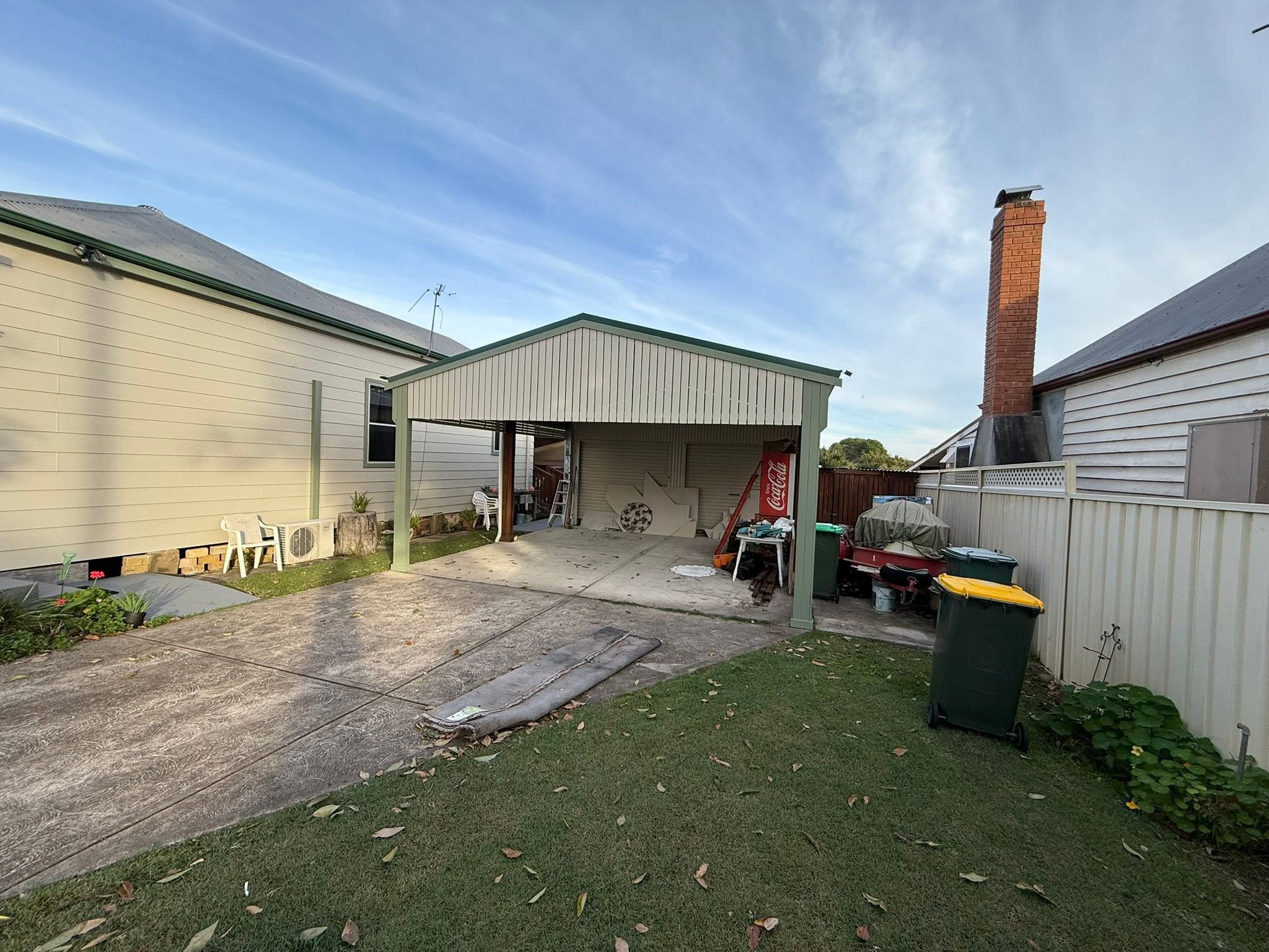Backyard weatherboard and carport after painting