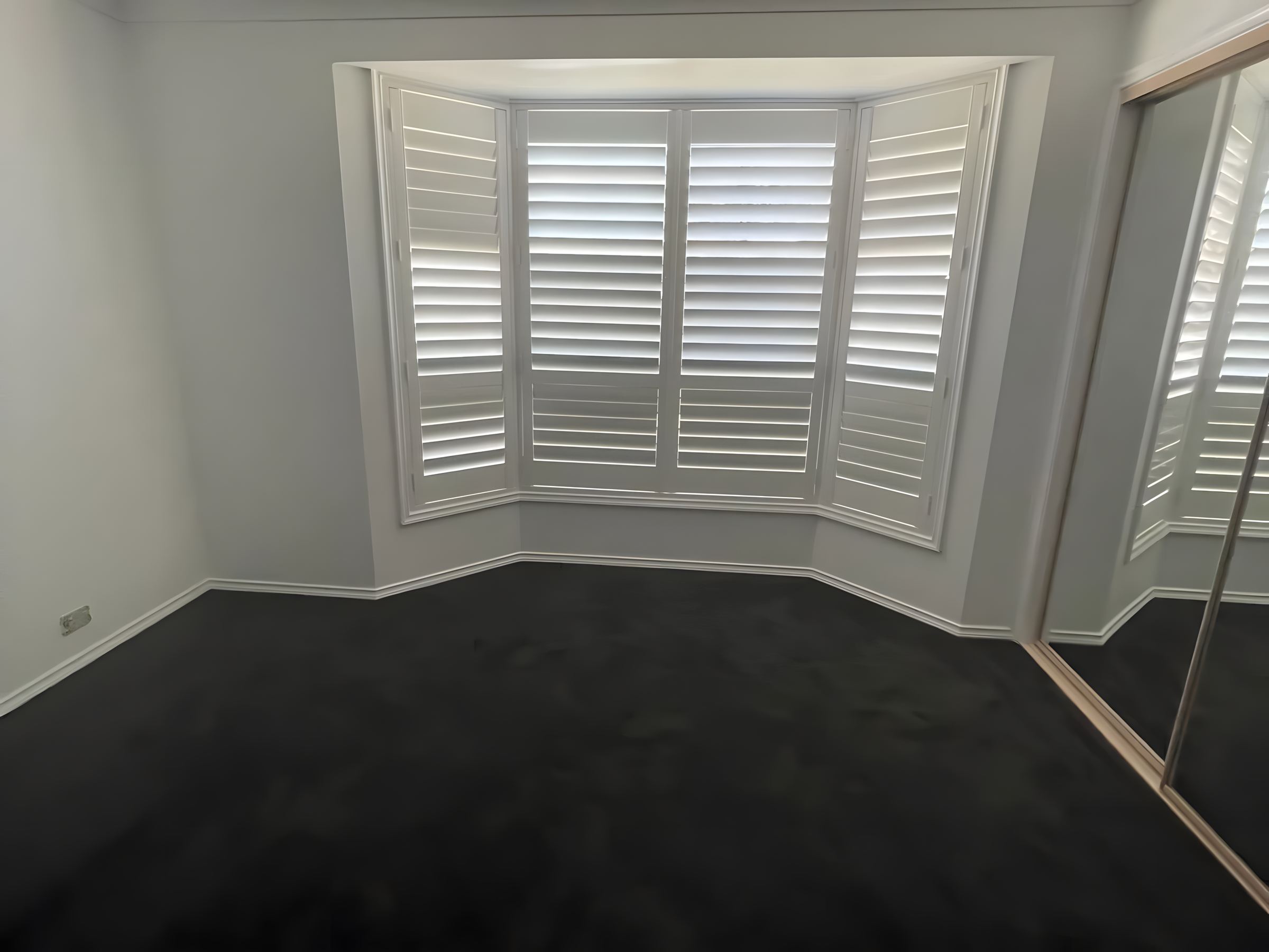 Bay window with shutters after painting