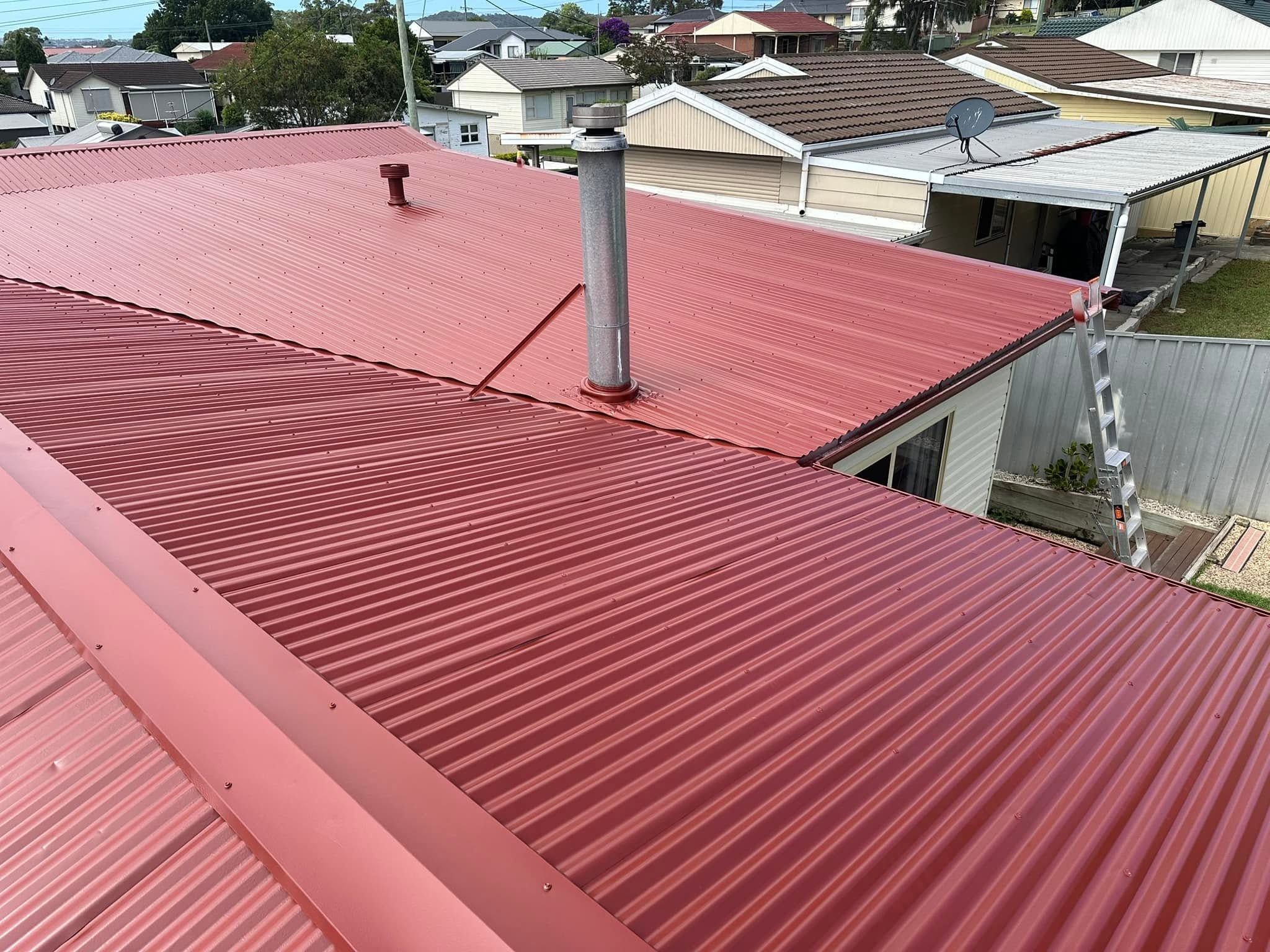 Red metal roof with a flue after a roof coating