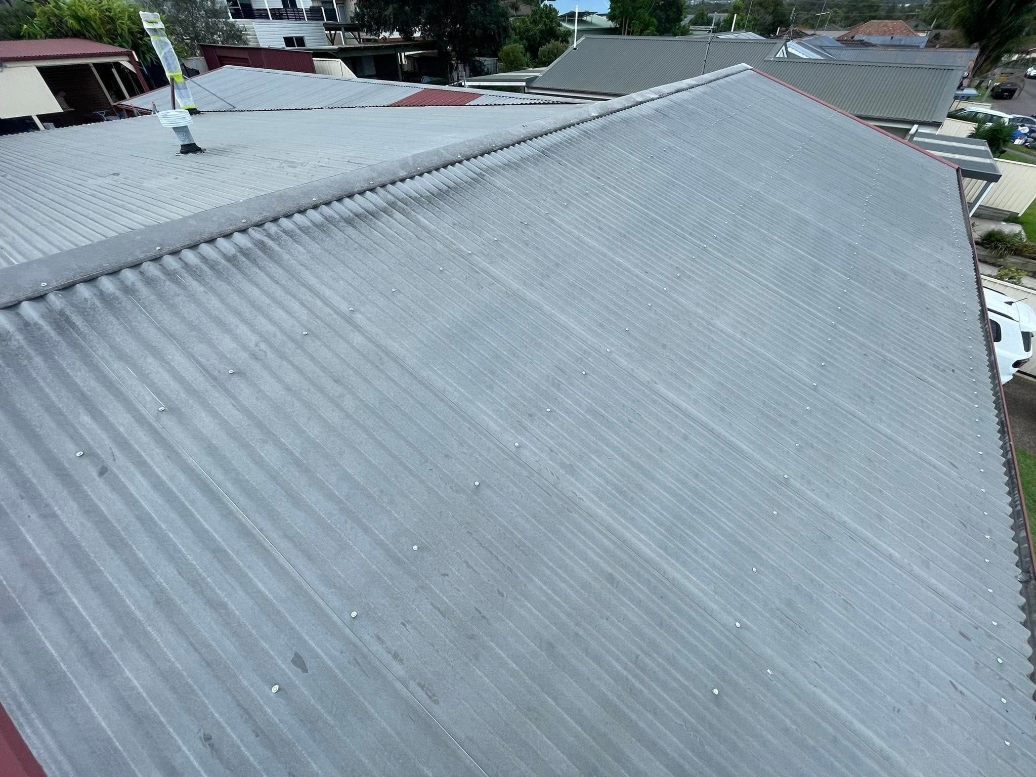 Weathered grey metal roof before painting
