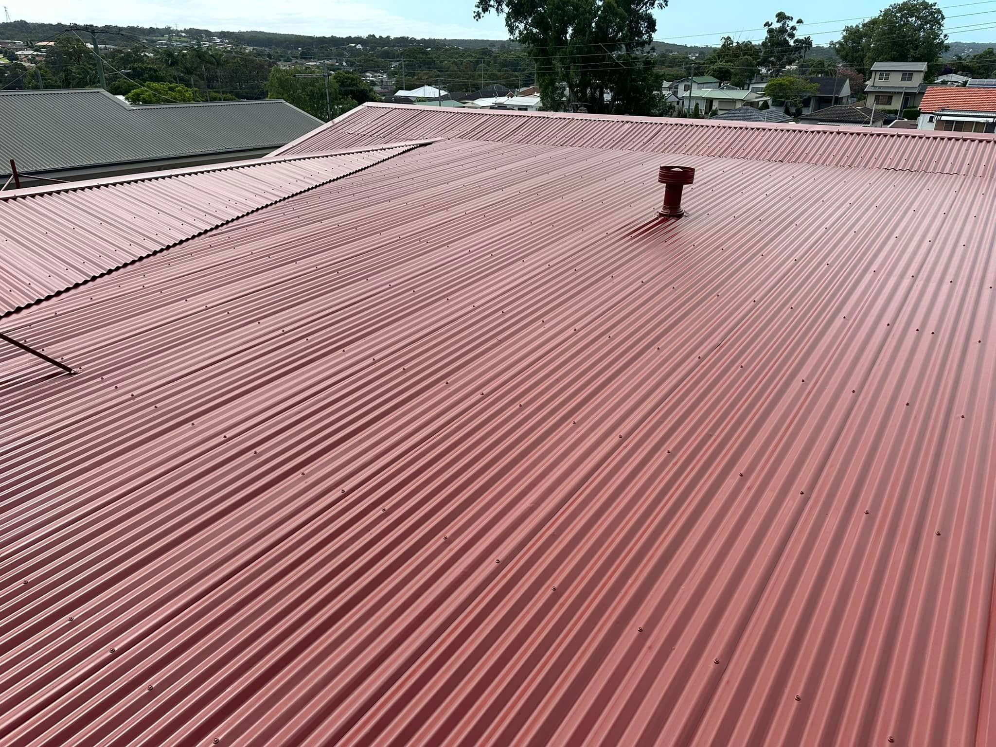 Red metal roof with a vent after a roof coating