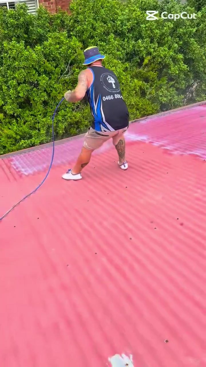 Jye Hughes spray painting a Colorbond roof on a Newcastle job