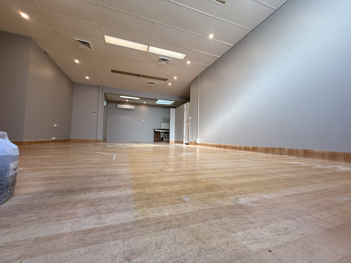 Empty shop in Warners Bay looking towards the back, freshly painted grey walls